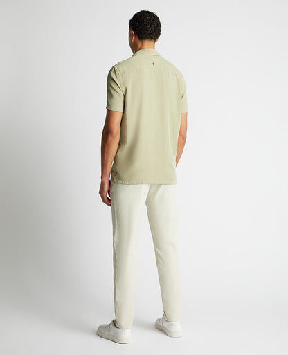 Man wearing a green Tapered Fit Short Sleeve Tencel Shirt