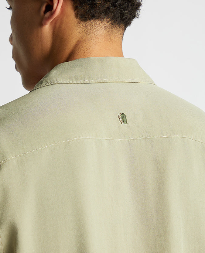 Man wearing a green Tapered Fit Short Sleeve Tencel Shirt