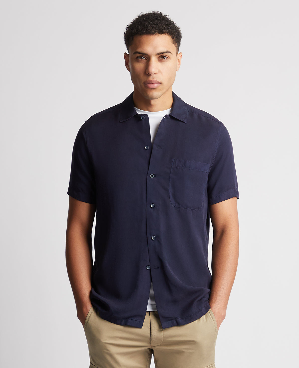 Man wearing a navy Tapered Fit Short Sleeve Tencel Shirt