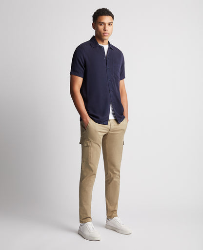 Man wearing a navy Tapered Fit Short Sleeve Tencel Shirt