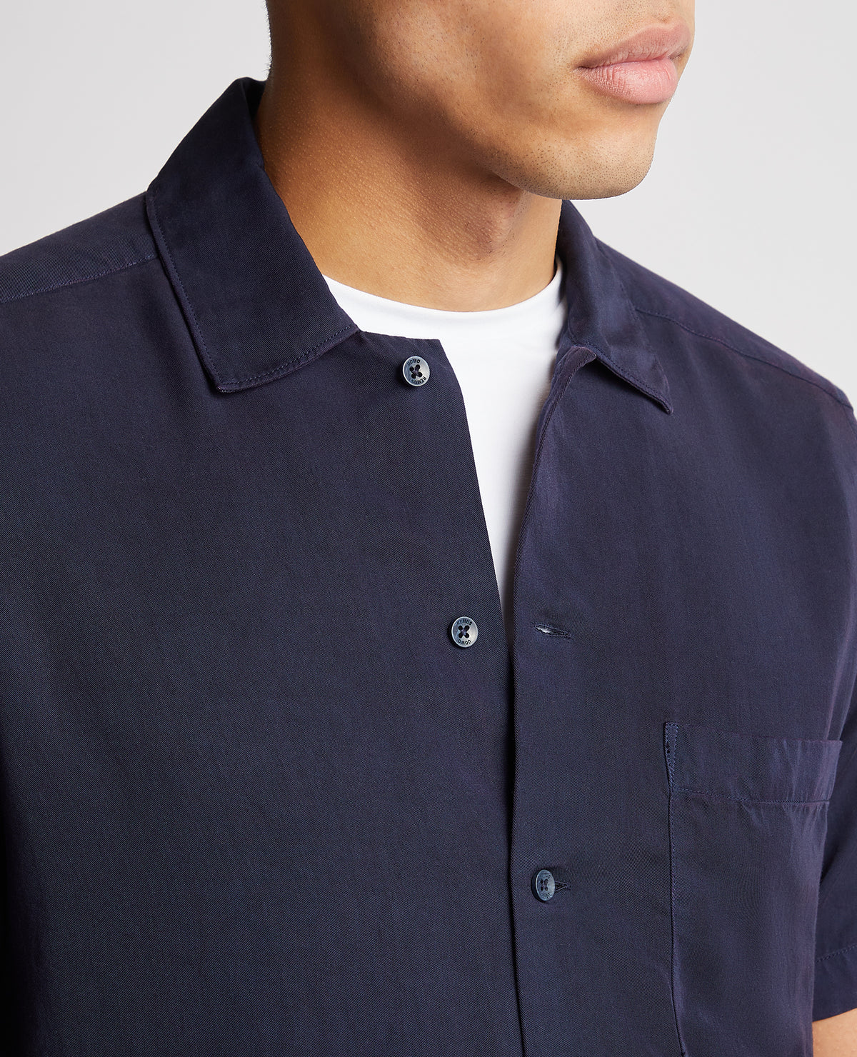 Man wearing a navy Tapered Fit Short Sleeve Tencel Shirt