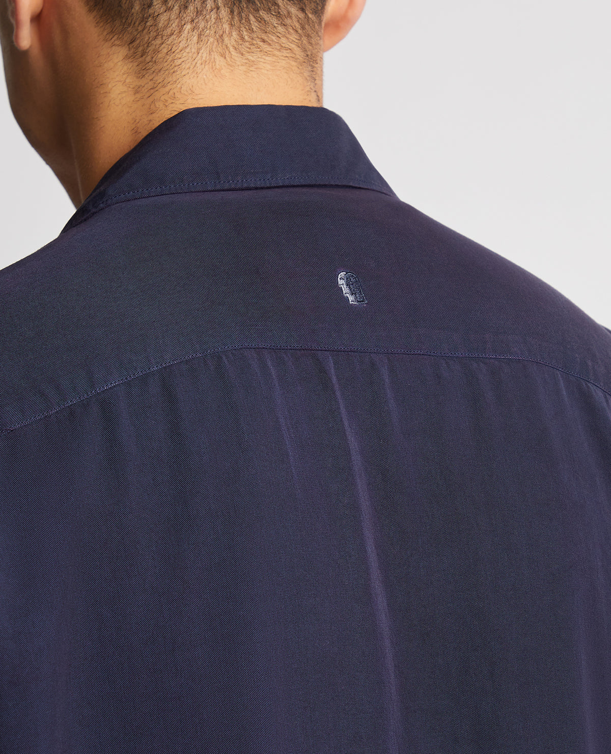 Man wearing a navy Tapered Fit Short Sleeve Tencel Shirt
