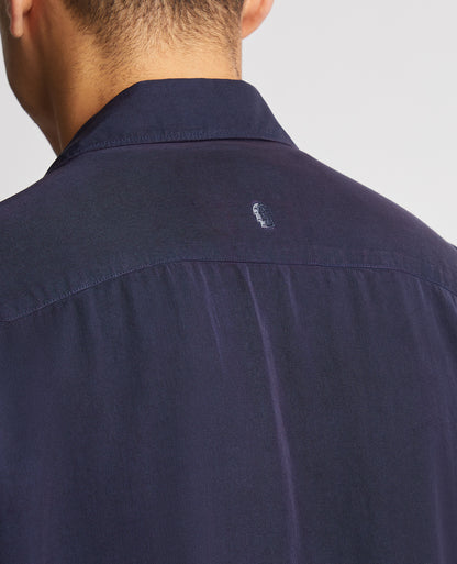 Man wearing a navy Tapered Fit Short Sleeve Tencel Shirt