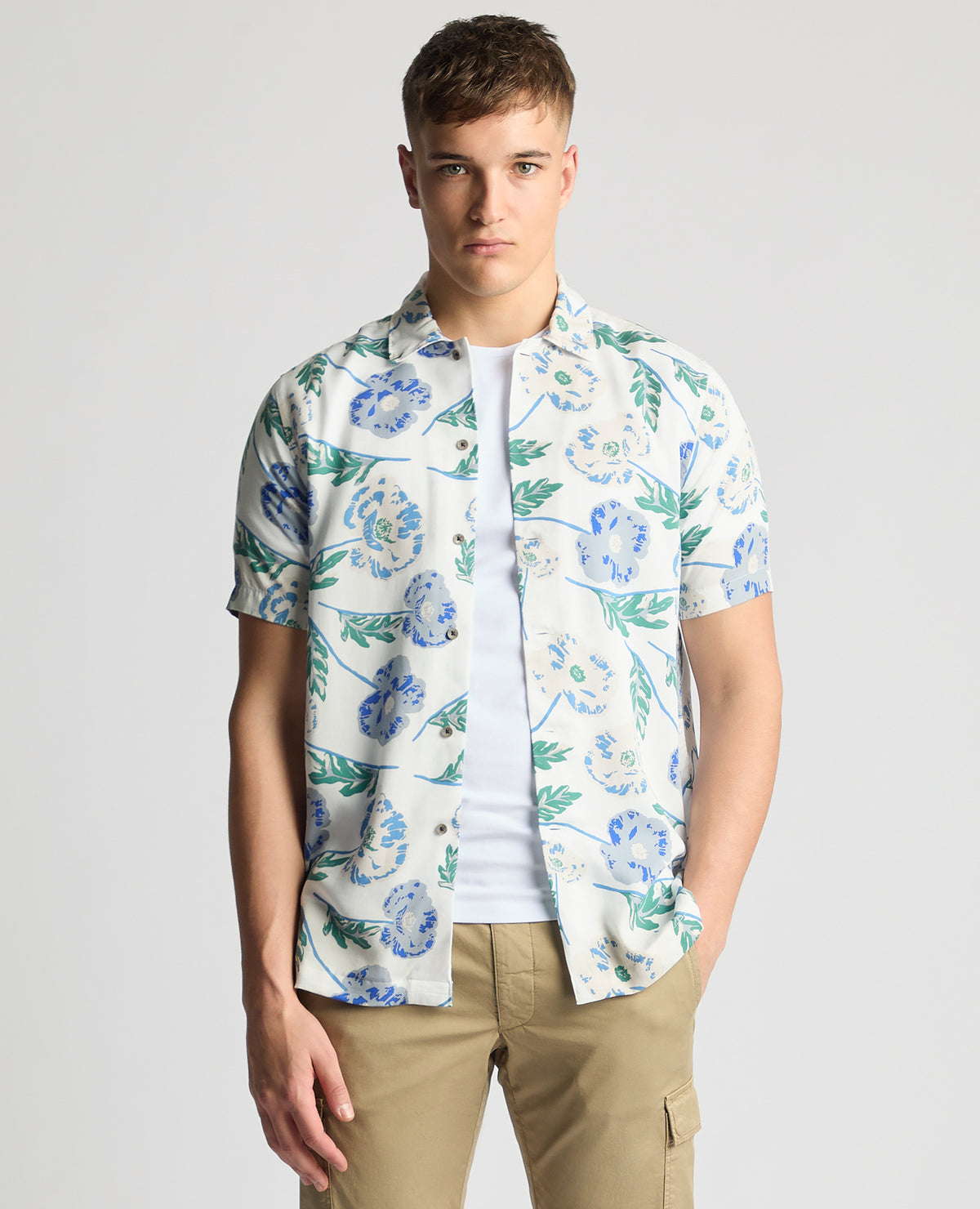 Man wearing a blue Tapered Fit Cotton Short Sleeve Floral Shirt