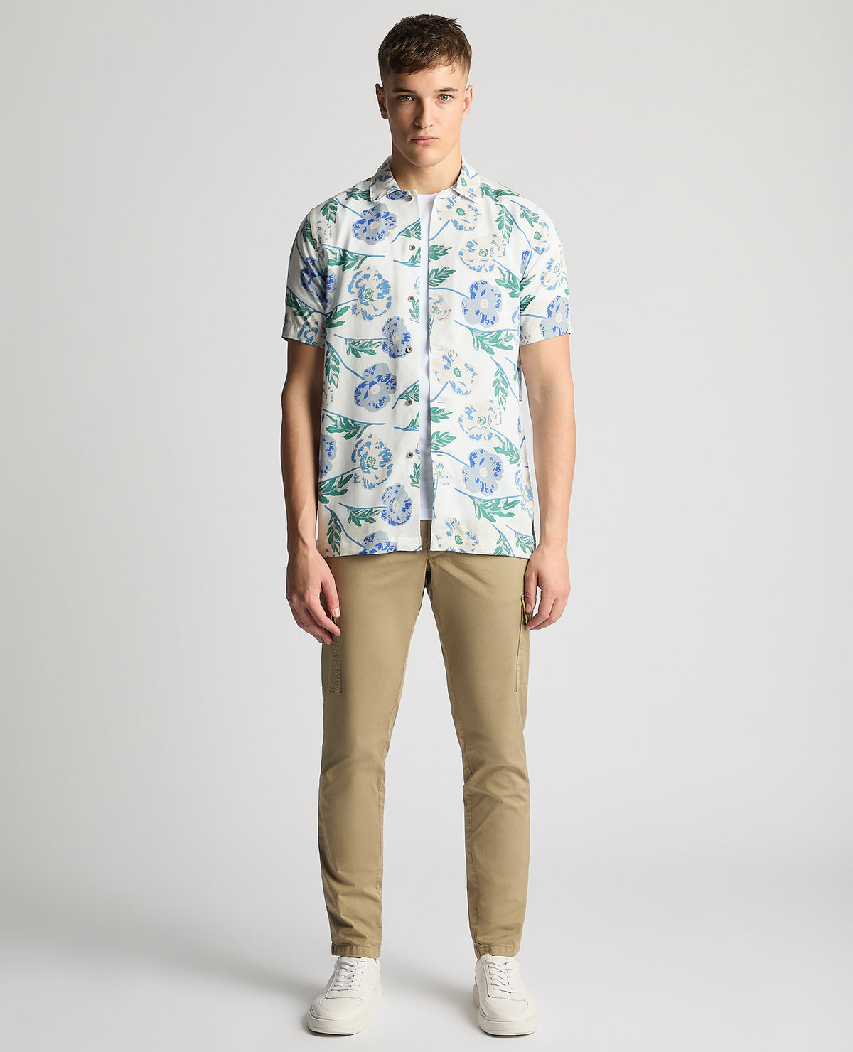 Man wearing a blue Tapered Fit Cotton Short Sleeve Floral Shirt