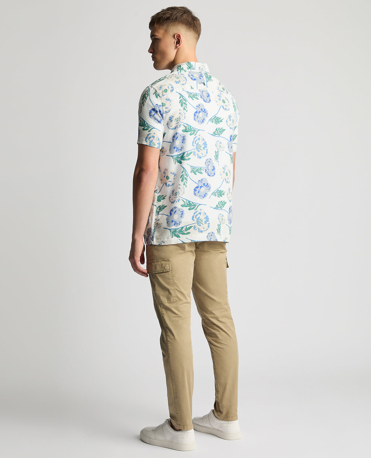 Man wearing a blue Tapered Fit Cotton Short Sleeve Floral Shirt