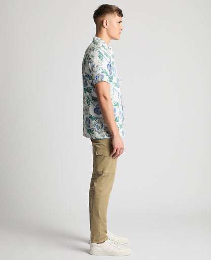 Man wearing a blue Tapered Fit Cotton Short Sleeve Floral Shirt