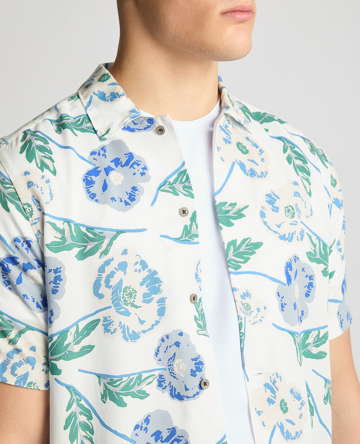 Man wearing a blue Tapered Fit Cotton Short Sleeve Floral Shirt