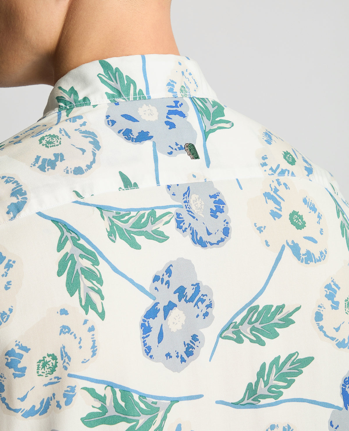 Man wearing a blue Tapered Fit Cotton Short Sleeve Floral Shirt
