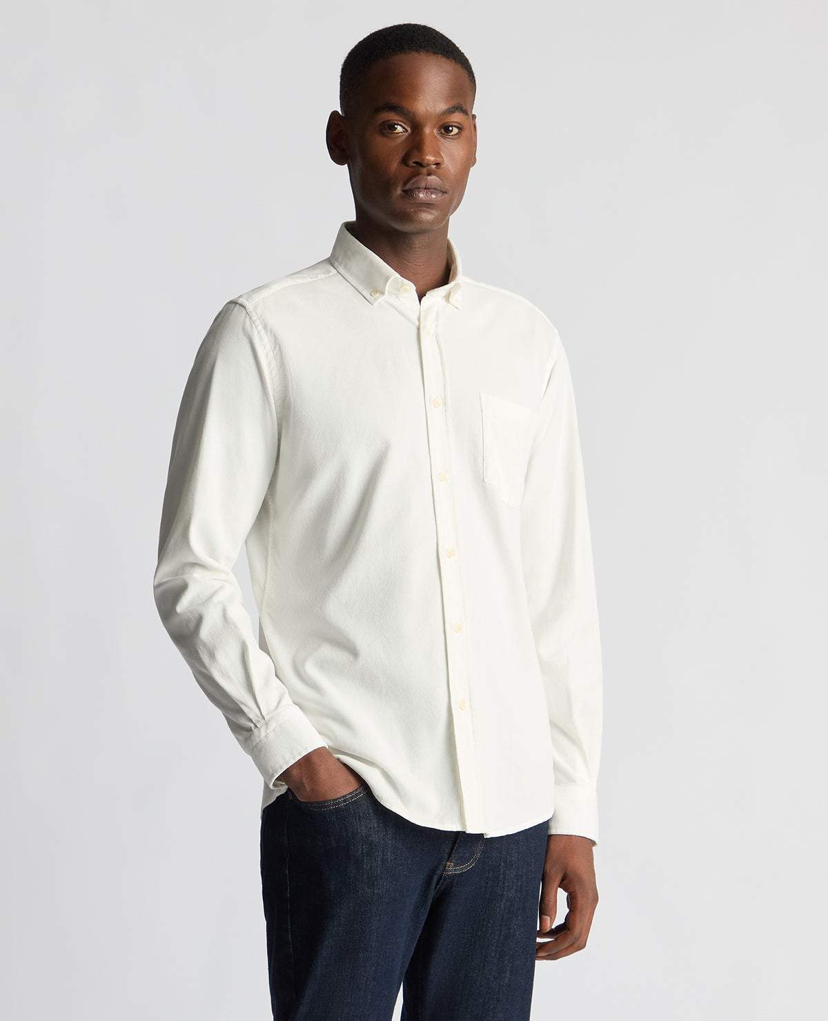 Man wearing a white Tapered Fit Micro Corduroy Shirt