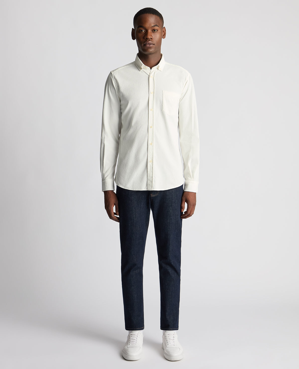 Man wearing a white Tapered Fit Micro Corduroy Shirt