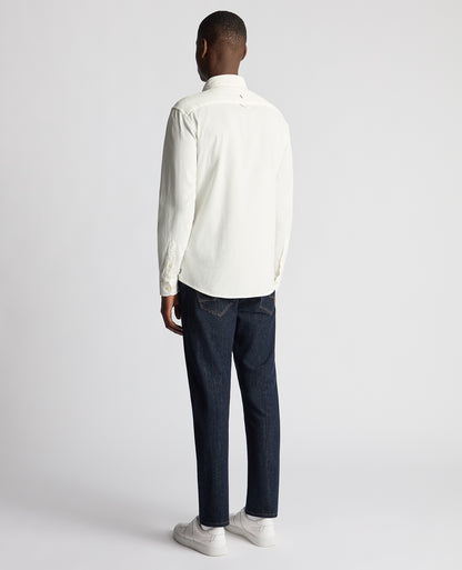 Man wearing a white Tapered Fit Micro Corduroy Shirt