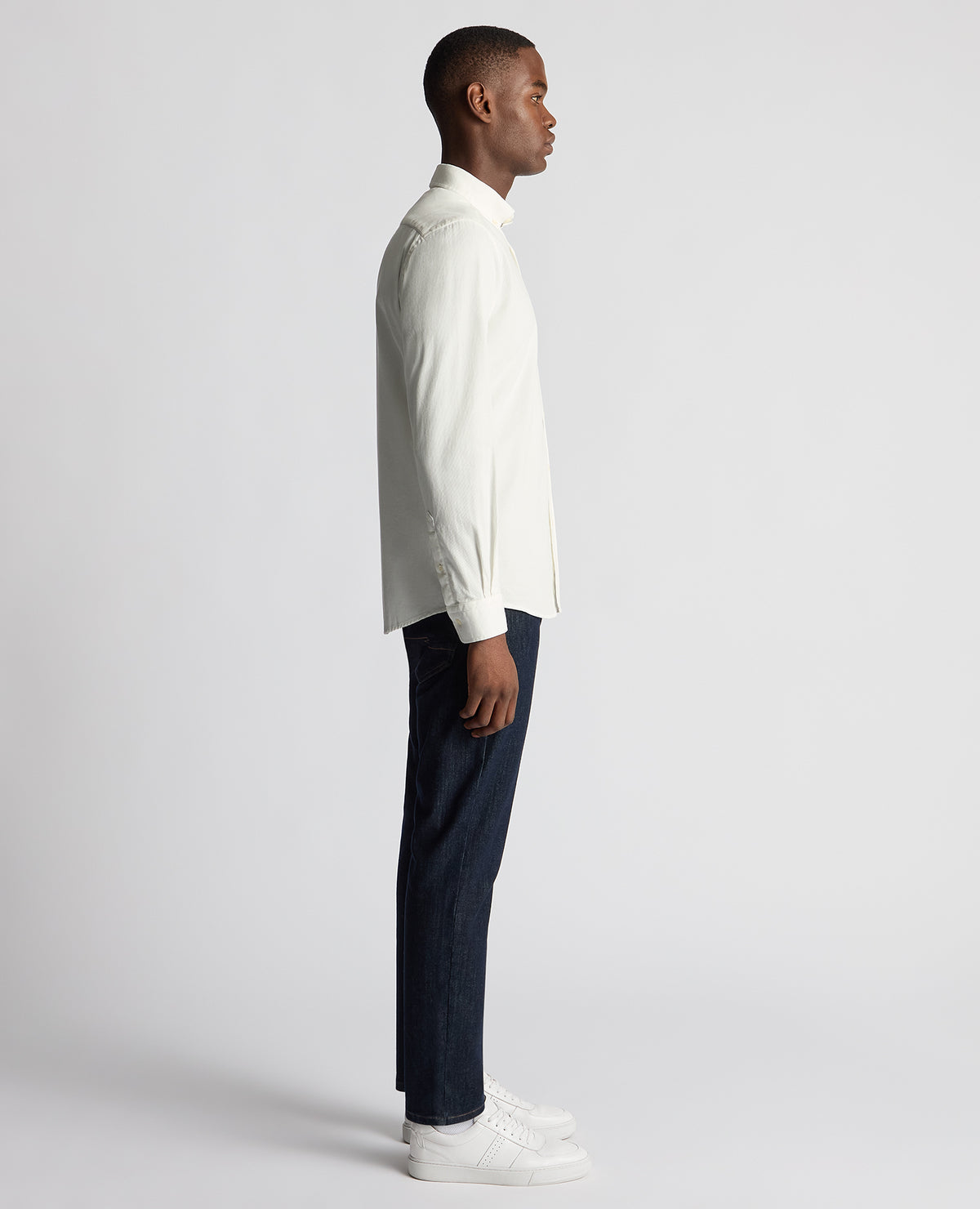 Man wearing a white Tapered Fit Micro Corduroy Shirt