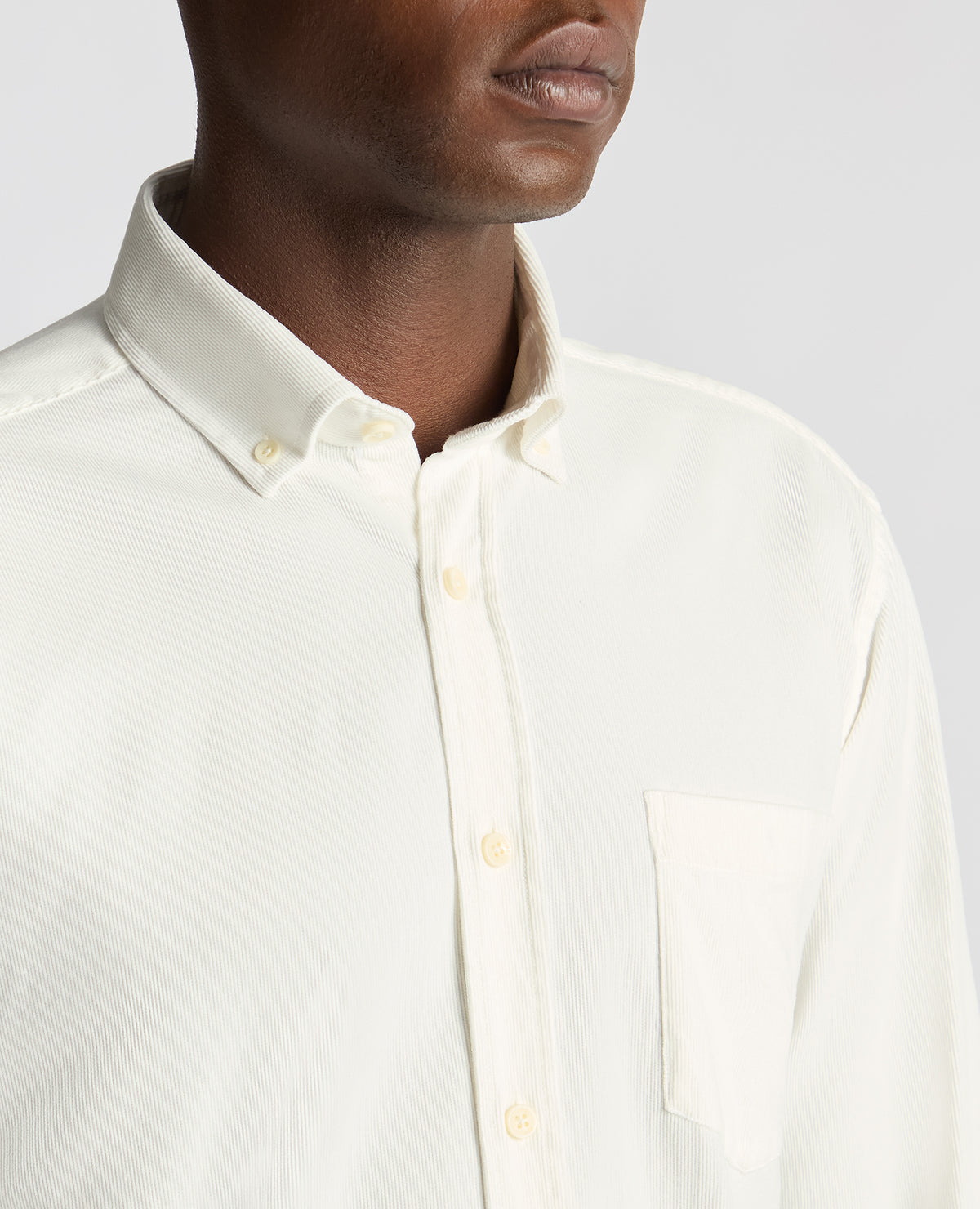 Man wearing a white Tapered Fit Micro Corduroy Shirt