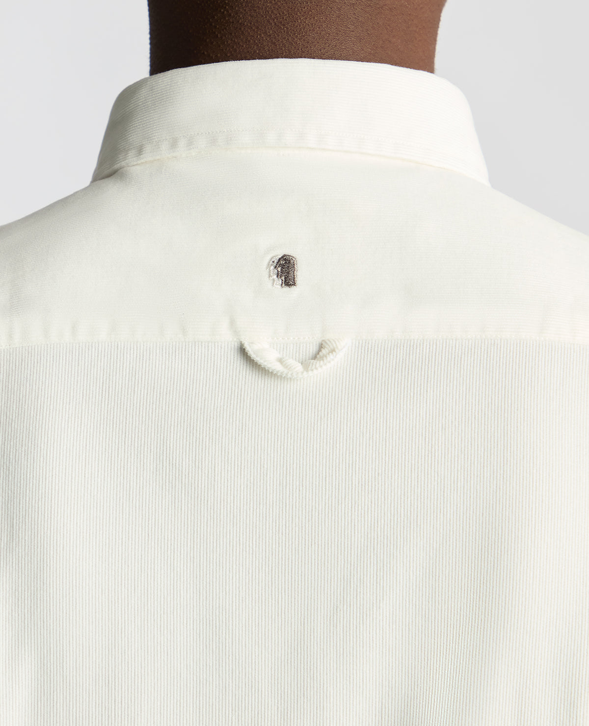 Man wearing a white Tapered Fit Micro Corduroy Shirt