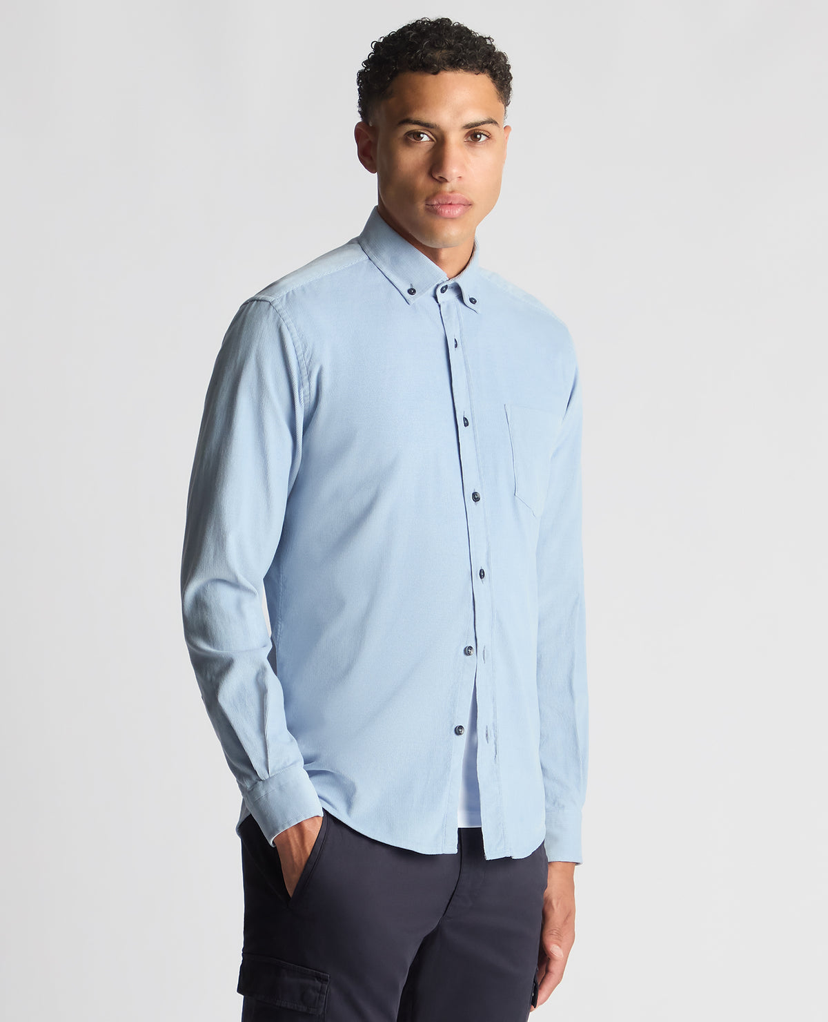 Man wearing a blue Tapered Fit Micro Corduroy Shirt
