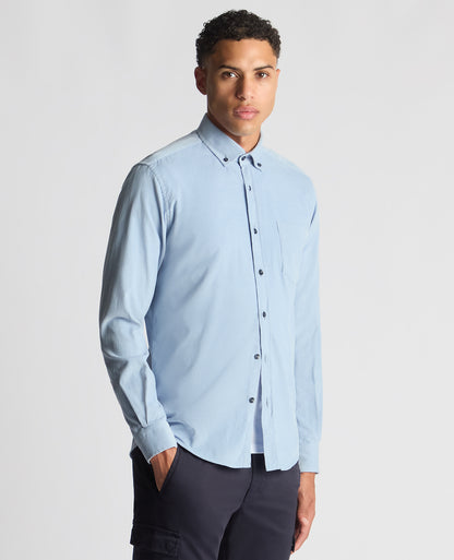 Man wearing a blue Tapered Fit Micro Corduroy Shirt
