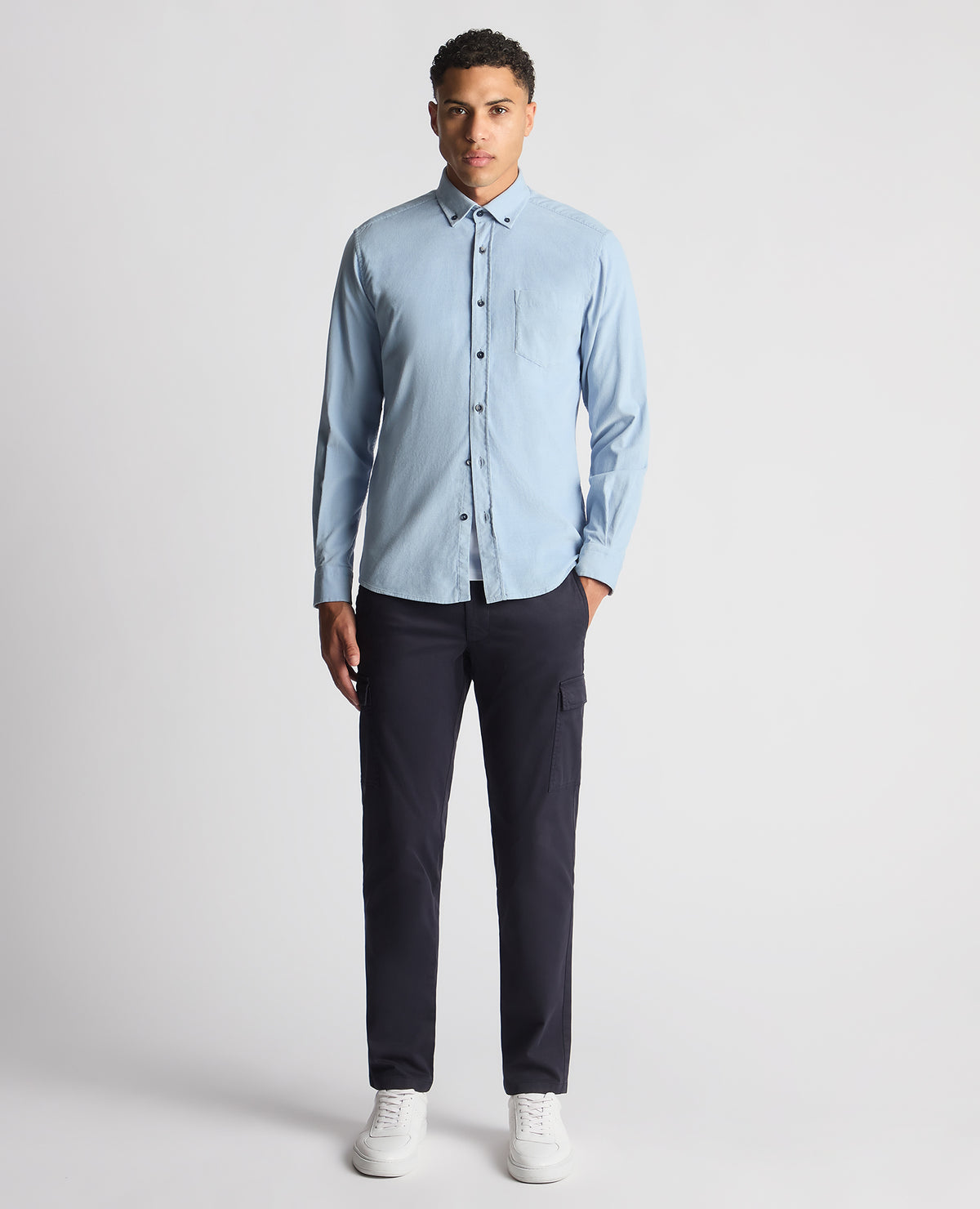 Man wearing a blue Tapered Fit Micro Corduroy Shirt