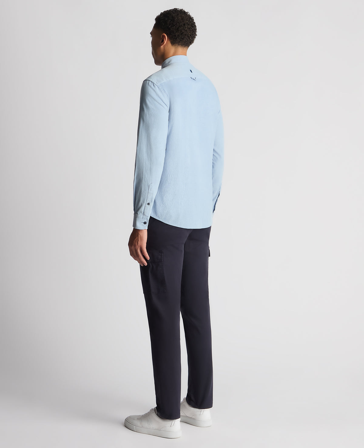 Man wearing a blue Tapered Fit Micro Corduroy Shirt