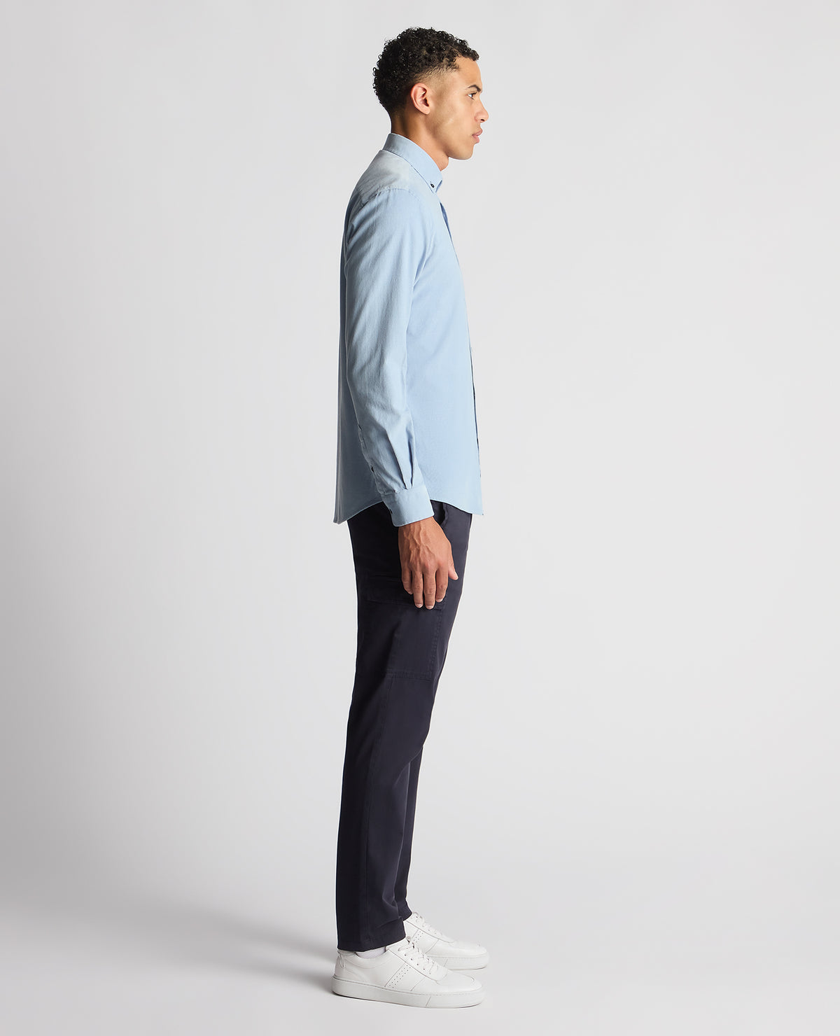 Man wearing a blue Tapered Fit Micro Corduroy Shirt