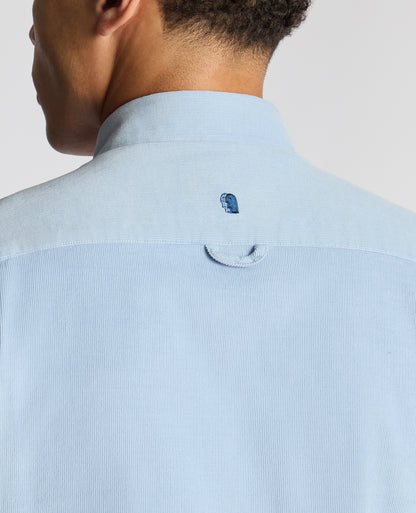 Man wearing a blue Tapered Fit Micro Corduroy Shirt