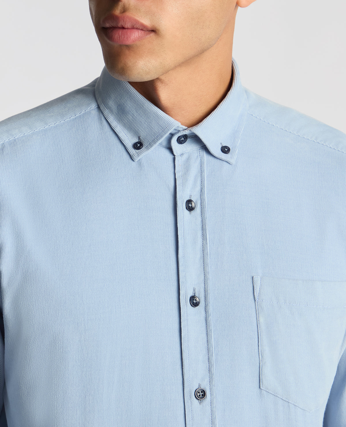 Man wearing a blue Tapered Fit Micro Corduroy Shirt