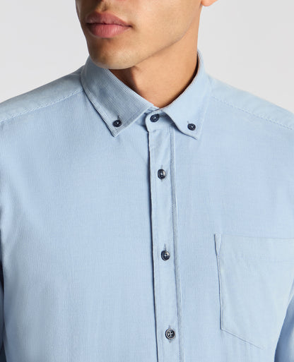 Man wearing a blue Tapered Fit Micro Corduroy Shirt