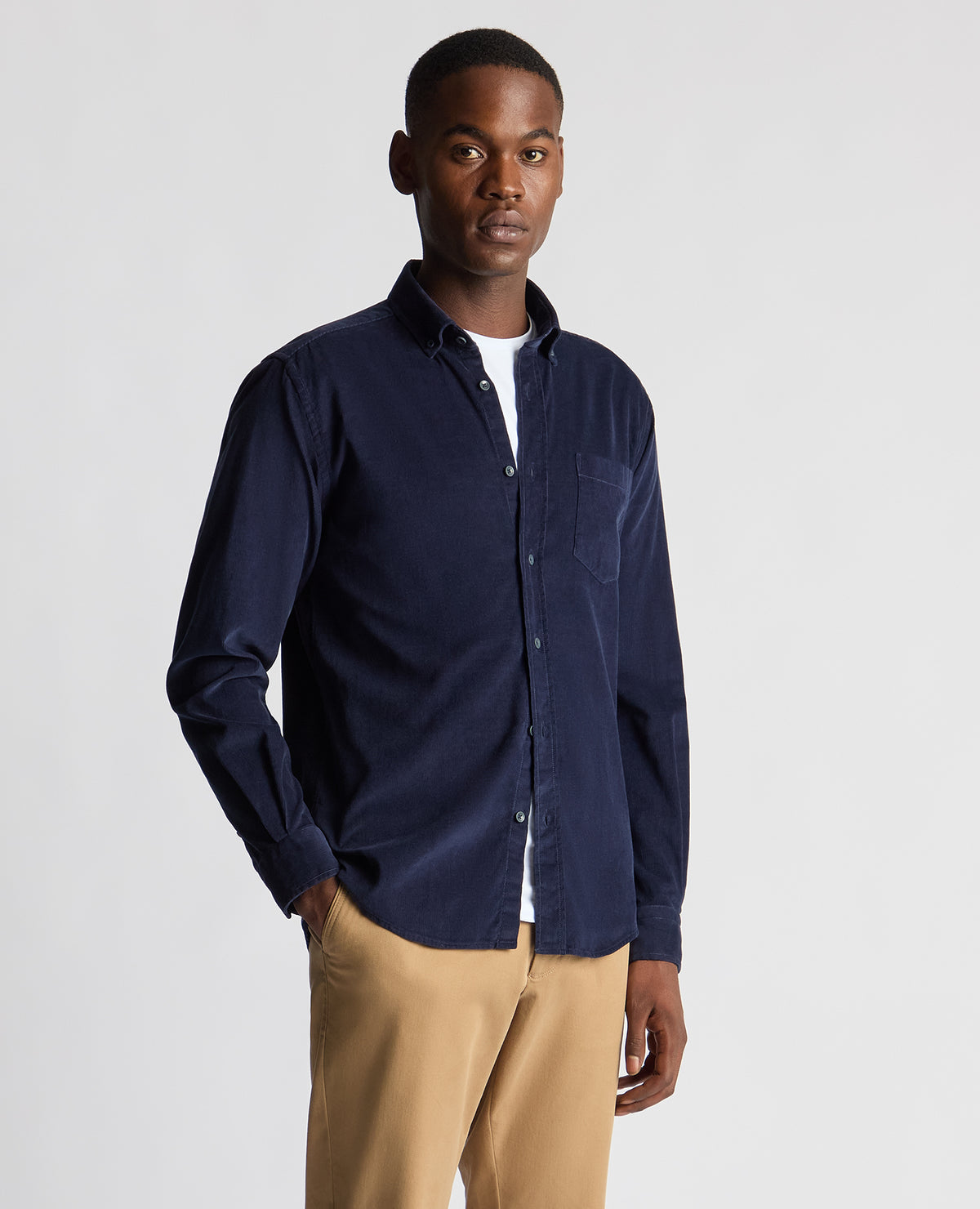 Man wearing a navy Tapered Fit Micro Corduroy Shirt