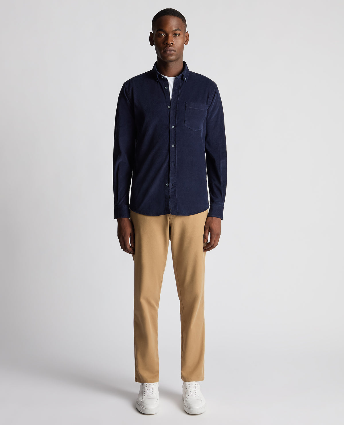 Man wearing a navy Tapered Fit Micro Corduroy Shirt