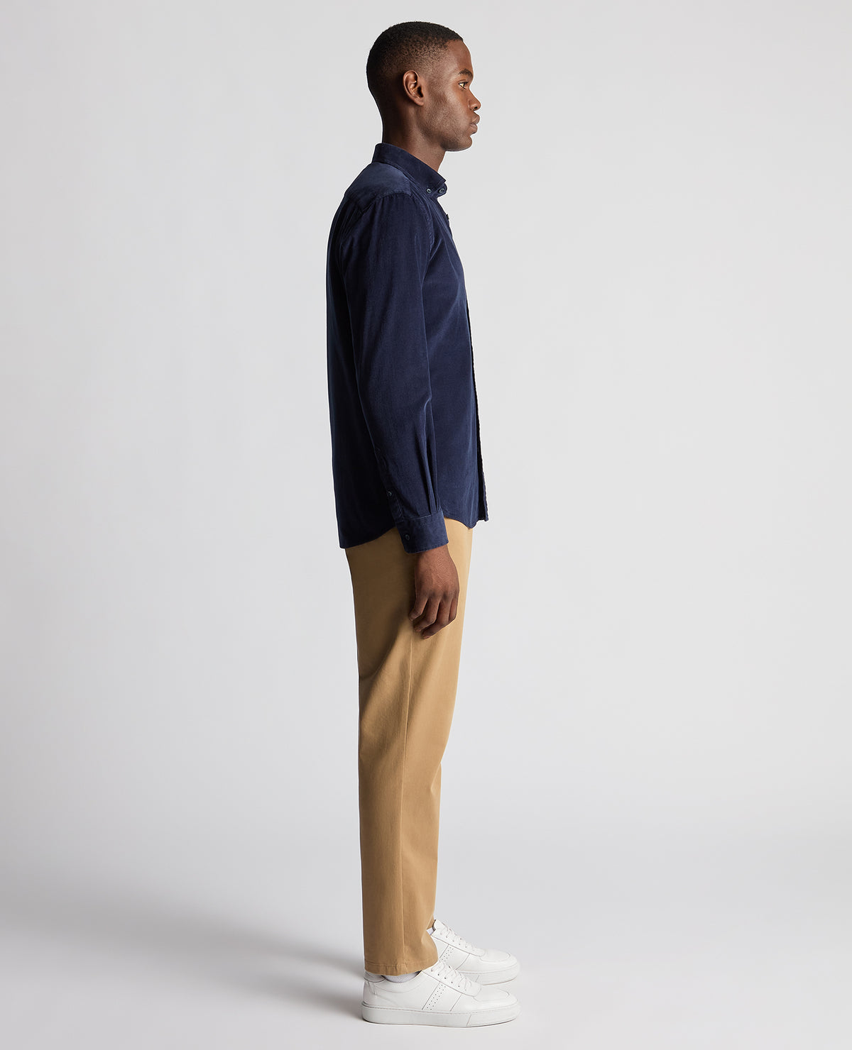 Man wearing a navy Tapered Fit Micro Corduroy Shirt