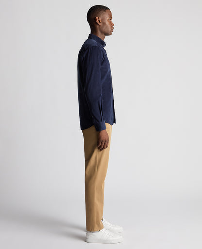 Man wearing a navy Tapered Fit Micro Corduroy Shirt