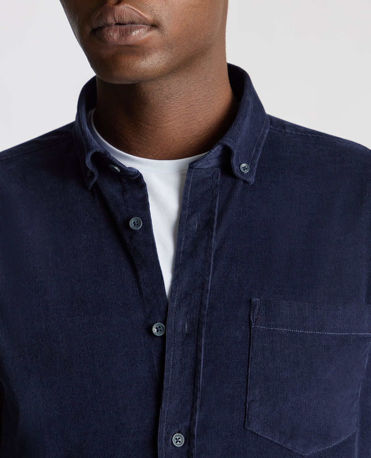 Man wearing a navy Tapered Fit Micro Corduroy Shirt