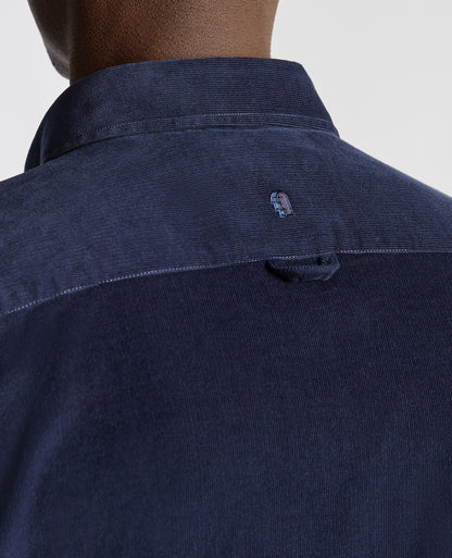 Man wearing a navy Tapered Fit Micro Corduroy Shirt