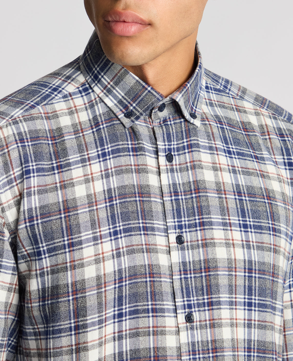 Man wearing a blue Tapered Fit Checked Brushed Cotton Shirt