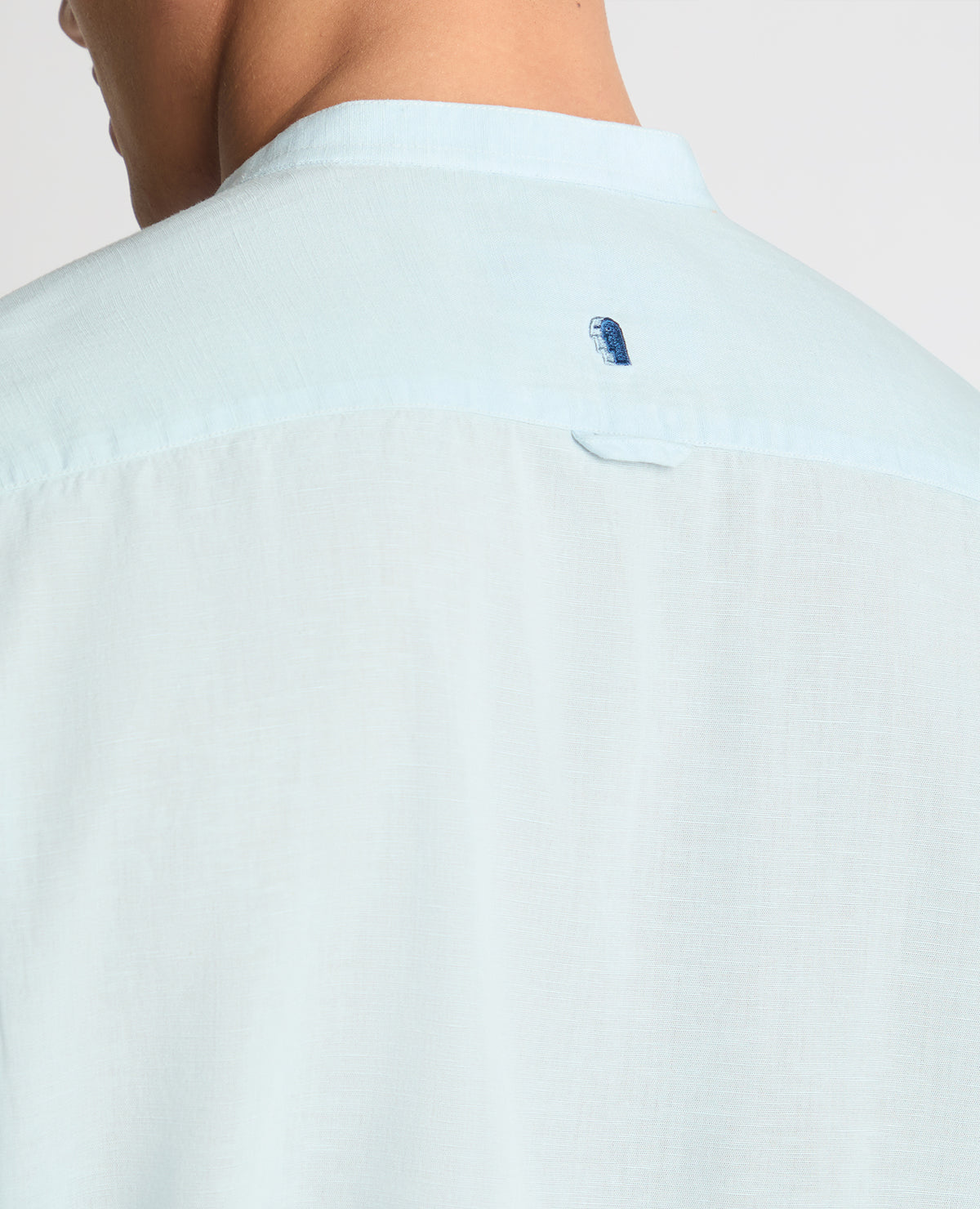Man wearing a blue casual shirt