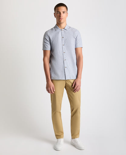 Man wearing a blue Tapered Fit Cotton-Linen Short Sleeve Shirt