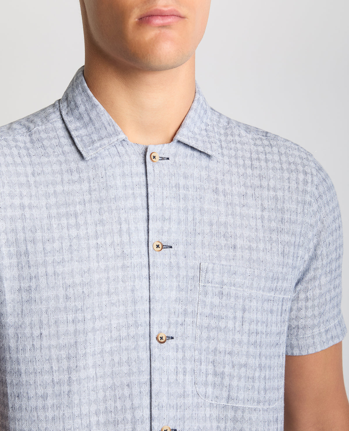 Man wearing a blue Tapered Fit Cotton-Linen Short Sleeve Shirt