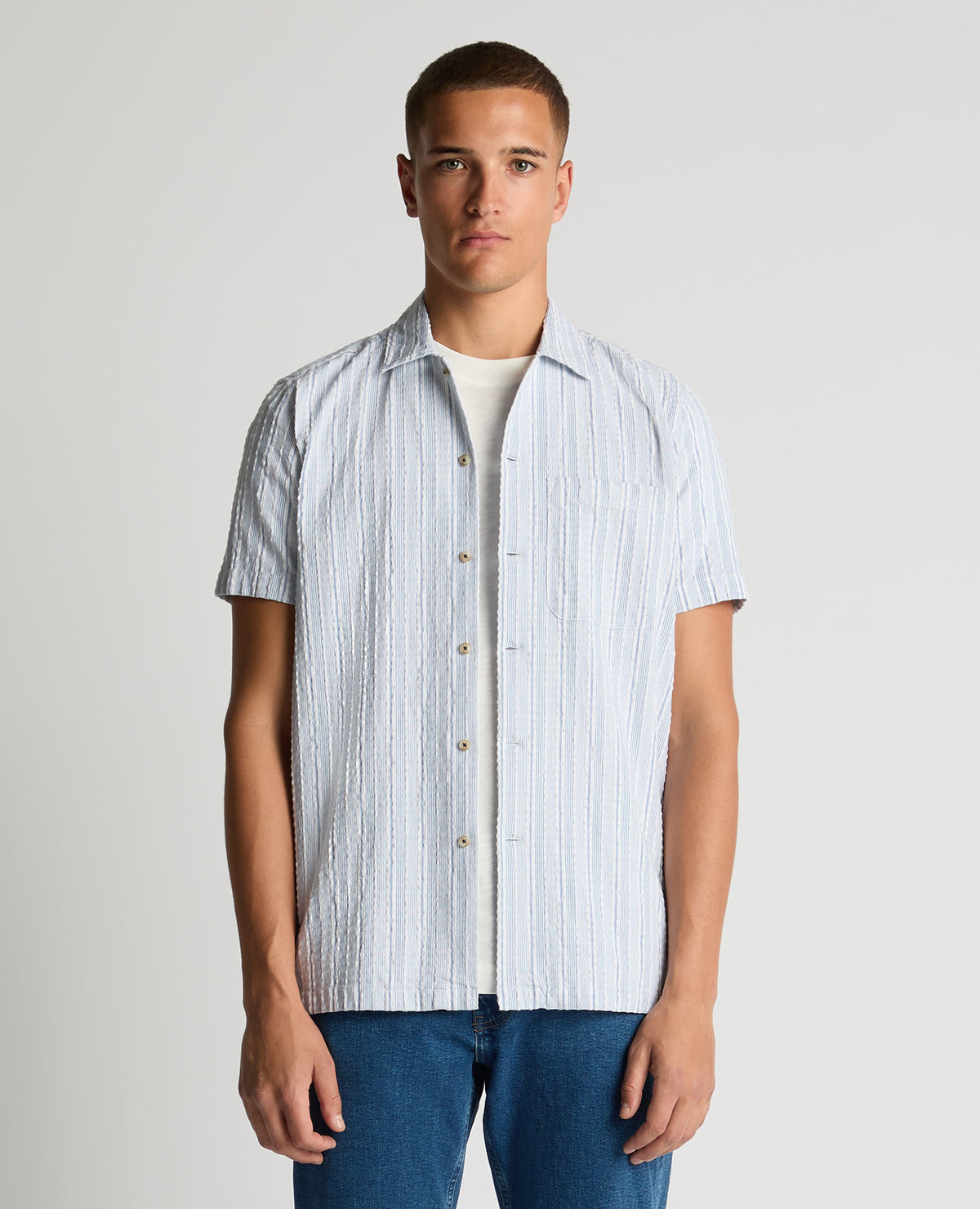 Man wearing a blue Tapered Fit Striped Seersucker Shirt