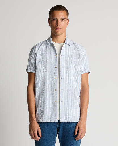 Man wearing a blue Tapered Fit Striped Seersucker Shirt