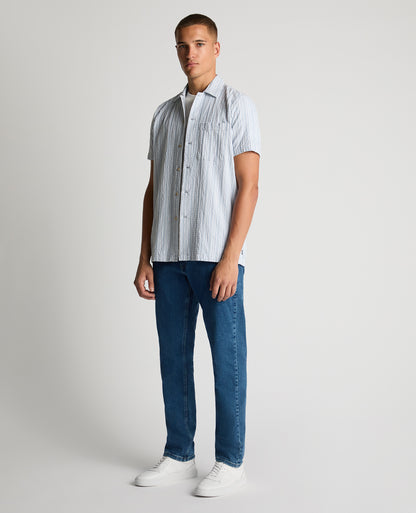 Man wearing a blue Tapered Fit Striped Seersucker Shirt