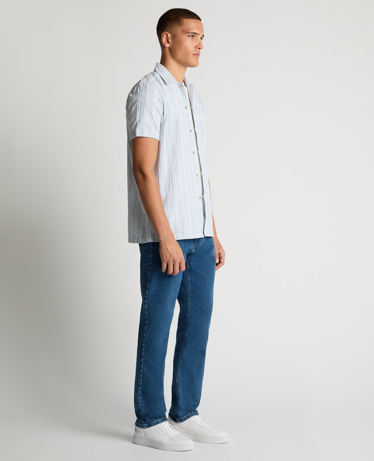 Man wearing a blue Tapered Fit Striped Seersucker Shirt