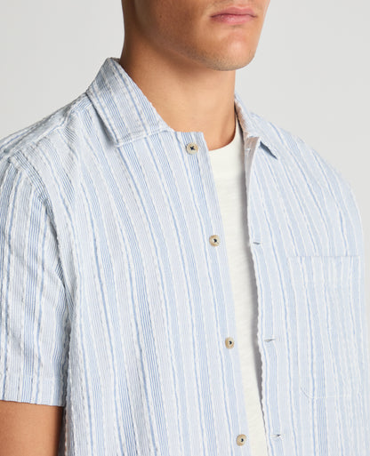 Man wearing a blue Tapered Fit Striped Seersucker Shirt