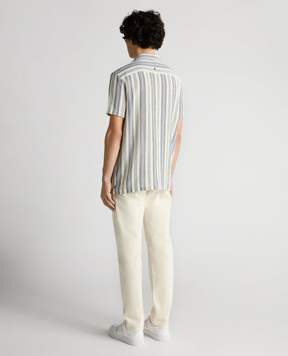 Man wearing a navy Tapered Fit Woven Cotton Striped Shirt
