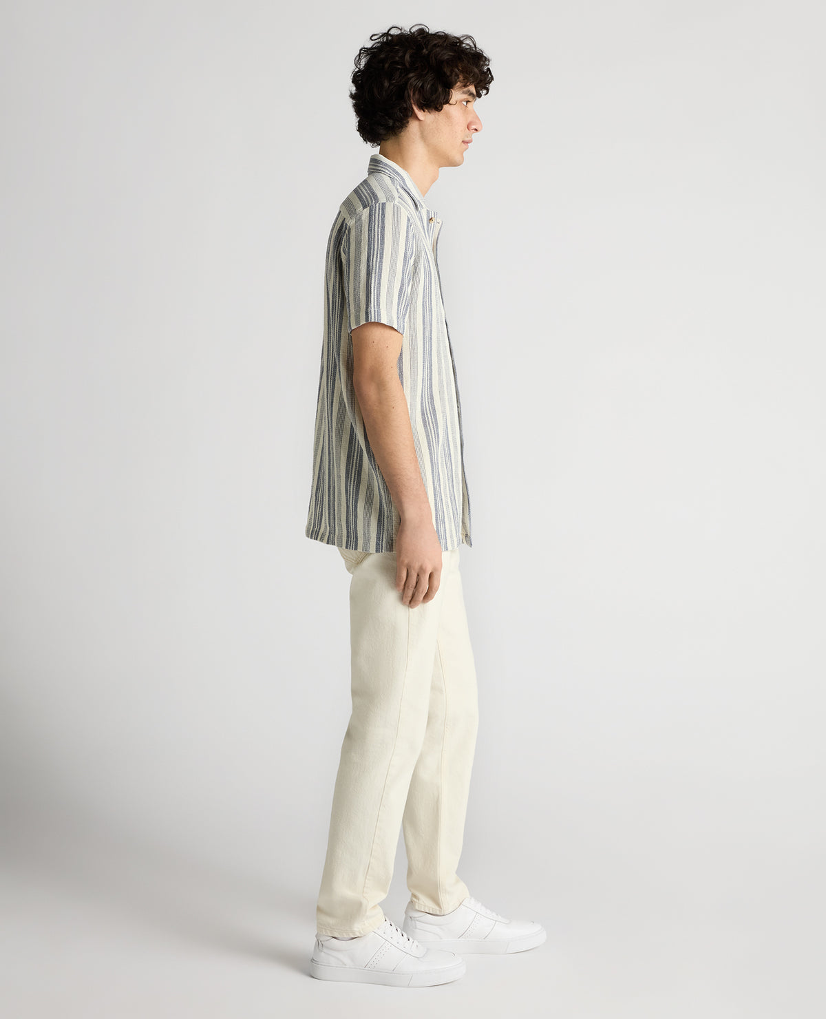 Man wearing a navy Tapered Fit Woven Cotton Striped Shirt