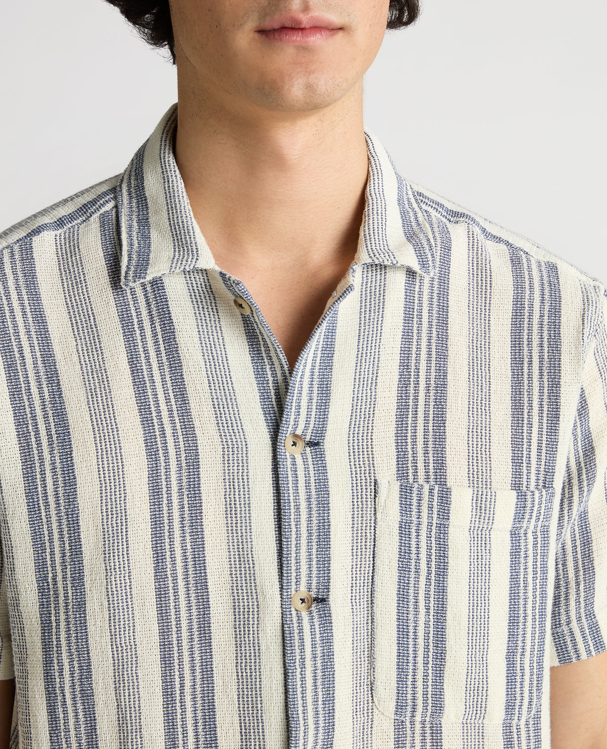 Man wearing a navy Tapered Fit Woven Cotton Striped Shirt