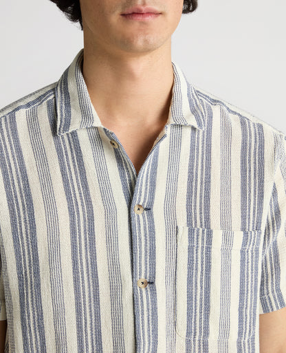 Man wearing a navy Tapered Fit Woven Cotton Striped Shirt