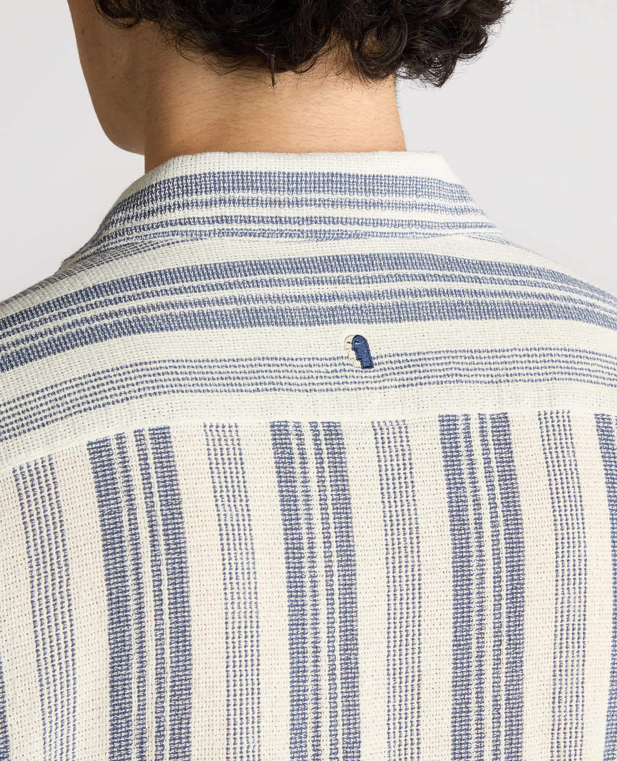 Man wearing a navy Tapered Fit Woven Cotton Striped Shirt