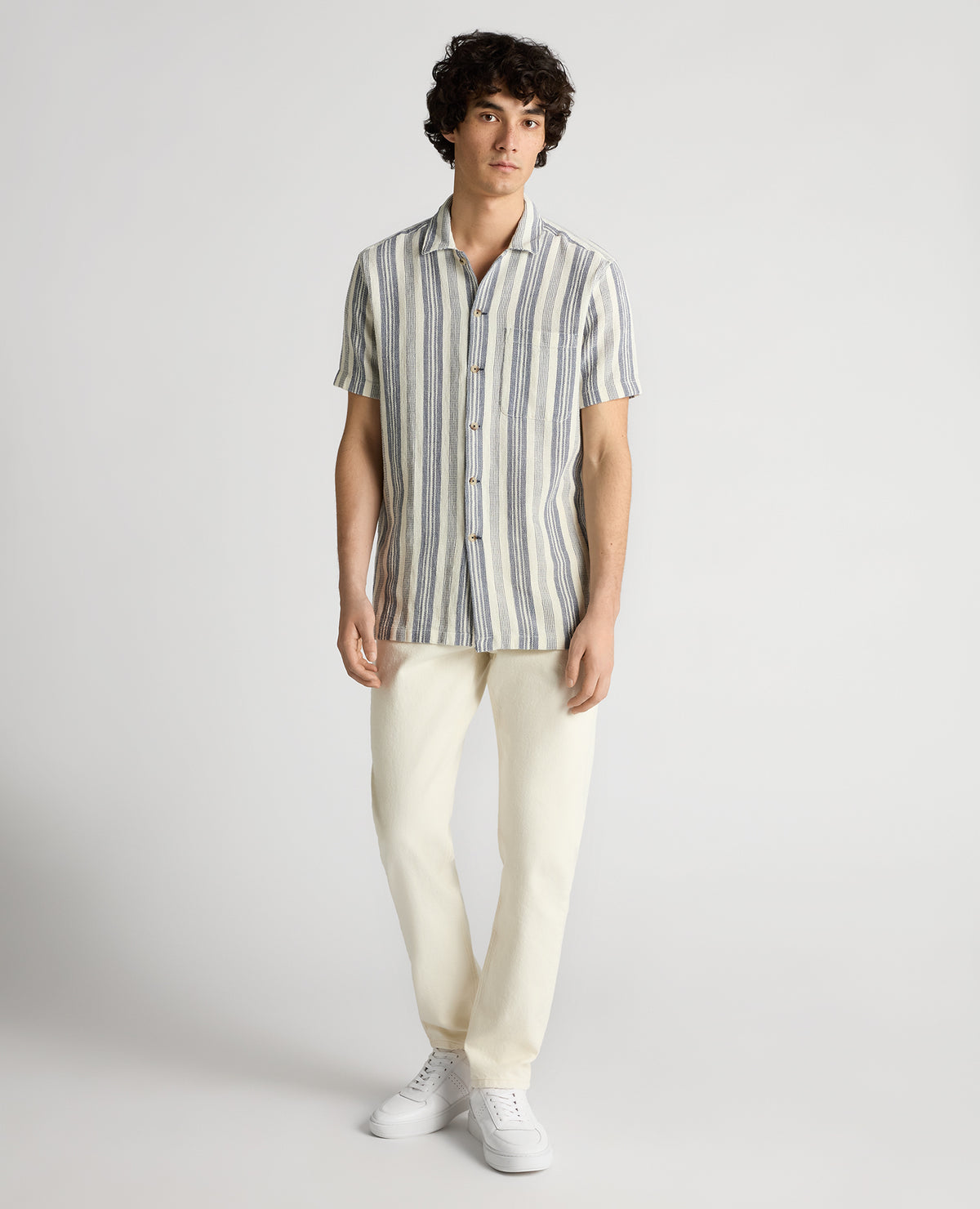 Man wearing a navy Tapered Fit Woven Cotton Striped Shirt