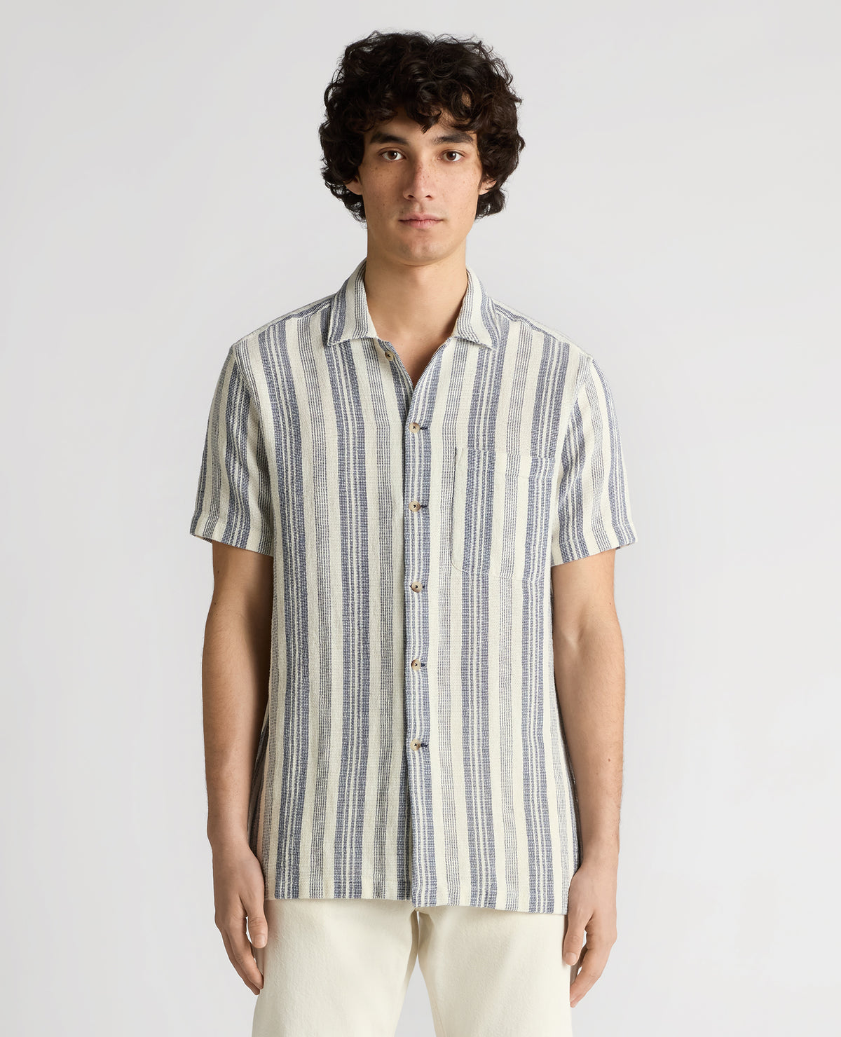 Man wearing a navy Tapered Fit Woven Cotton Striped Shirt