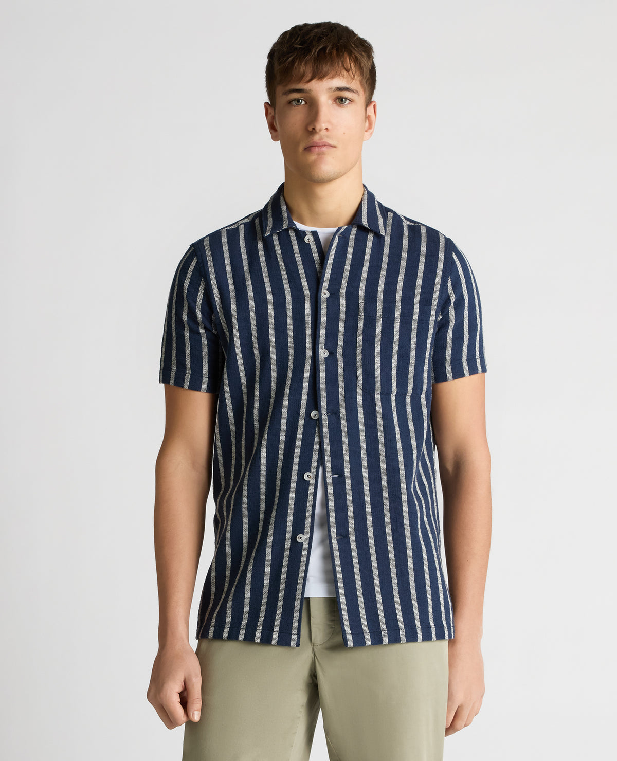 Man wearing a navy Tapered Fit Striped Cotton-Blend Shirt